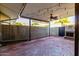 Covered back patio with brick flooring, a ceiling fan, string lights, and a brick fireplace at 4800 N 68Th St # 385, Scottsdale, AZ 85251