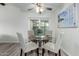 Cozy dining area features a glass-topped table and three upholstered chairs, plus an overhead fan at 4800 N 68Th St # 385, Scottsdale, AZ 85251