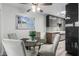 Dining area featuring a glass table, three chairs, modern lighting, and a beach view at 4800 N 68Th St # 385, Scottsdale, AZ 85251