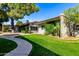 Well-maintained home featuring lush landscaping, grassy lawn, and charming curb appeal at 4800 N 68Th St # 385, Scottsdale, AZ 85251