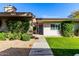 Charming home with inviting walkway, lush landscaping, and a well-manicured front yard at 4800 N 68Th St # 385, Scottsdale, AZ 85251