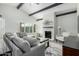 Comfortable living area with brick fireplace, gray sofa, and views of the backyard at 4800 N 68Th St # 385, Scottsdale, AZ 85251
