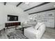 Bright living room featuring a comfortable gray sofa and stylish built-in bookshelves at 4800 N 68Th St # 385, Scottsdale, AZ 85251
