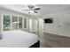 Spacious bedroom features wood-look flooring, a ceiling fan, and plenty of natural light at 4800 N 68Th St # 385, Scottsdale, AZ 85251