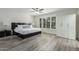 Spacious main bedroom features wood-look flooring, large windows, and a modern ceiling fan at 4800 N 68Th St # 385, Scottsdale, AZ 85251