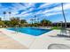 Large community pool with sparkling blue water, surrounded by palm trees and lounge chairs at 4800 N 68Th St # 385, Scottsdale, AZ 85251
