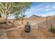 Backyard with a stone water feature, desert landscaping, fire pit, and block wall for privacy at 5002 W Wikieup Ln, Glendale, AZ 85308