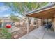 Backyard with a covered patio, grill, and charming stone accents offer a relaxed outdoor living space at 5002 W Wikieup Ln, Glendale, AZ 85308