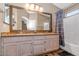 Bathroom featuring double sinks, granite counters, shower/tub combo and luxury vinyl floors at 5002 W Wikieup Ln, Glendale, AZ 85308