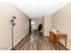 This bright bedroom features wood floors, a window, and a stylish black chair at 5002 W Wikieup Ln, Glendale, AZ 85308