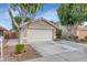 Charming single-story home with a spacious two-car garage and desert landscaping at 5002 W Wikieup Ln, Glendale, AZ 85308