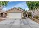 Charming single-story home with a spacious two-car garage and desert landscaping at 5002 W Wikieup Ln, Glendale, AZ 85308