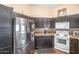 This kitchen features espresso cabinets, stainless steel appliances, and an electric stove at 5002 W Wikieup Ln, Glendale, AZ 85308
