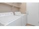 Bright laundry room with shelving and machines at 5002 W Wikieup Ln, Glendale, AZ 85308