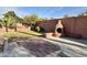 View of the backyard with grass area and a custom-built outdoor fireplace against a block wall at 5031 S Roosevelt St, Tempe, AZ 85282