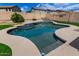Private backyard featuring a captivating pool, an artificial lawn, and meticulous landscaping for serene outdoor living at 504 E Quentin Ln, San Tan Valley, AZ 85140