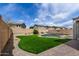 Spacious backyard showcasing artificial turf, gravel landscaping, block fence, and a refreshing pool area at 504 E Quentin Ln, San Tan Valley, AZ 85140