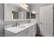 Bathroom featuring double sinks, marble countertops, a white door, and brushed nickel hardware at 504 E Quentin Ln, San Tan Valley, AZ 85140