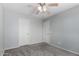 Bedroom featuring neutral gray walls, carpet, ceiling fan and two white doors at 504 E Quentin Ln, San Tan Valley, AZ 85140