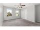 Bedroom with a ceiling fan, two windows, neutral paint, and carpeted floors at 504 E Quentin Ln, San Tan Valley, AZ 85140