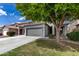Charming two-story home featuring a well-maintained front yard, a two car garage and mature landscaping at 504 E Quentin Ln, San Tan Valley, AZ 85140