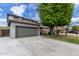 Charming two-story home with a well-maintained front yard and a gray two-car garage at 504 E Quentin Ln, San Tan Valley, AZ 85140