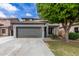 Charming two-story home featuring a well-maintained front yard, a two car garage and mature landscaping at 504 E Quentin Ln, San Tan Valley, AZ 85140