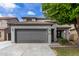 Charming two-story home featuring a well-maintained front yard, a two car garage and mature landscaping at 504 E Quentin Ln, San Tan Valley, AZ 85140