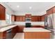 Kitchen with stainless steel appliances, an island counter and plenty of storage at 504 E Quentin Ln, San Tan Valley, AZ 85140