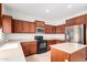 Well-equipped kitchen with stainless steel appliances, wooden cabinets, and center island for food preparation and storage at 504 E Quentin Ln, San Tan Valley, AZ 85140