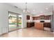 Stylish kitchen featuring wooden cabinets, stainless steel appliances, and sliding door with views of a sparkling pool at 504 E Quentin Ln, San Tan Valley, AZ 85140