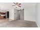 Open floor plan to carpeted living room, decorative barn door and adjoining kitchen with stainless appliances at 504 E Quentin Ln, San Tan Valley, AZ 85140