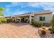 Inviting back patio featuring a paved area with patio furniture and well-maintained landscaping at 5548 W Victory Way, Florence, AZ 85132