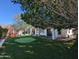 Expansive backyard featuring a putting green and lush lawn, ideal for recreation and relaxation at 6016 W Gambit Trl, Phoenix, AZ 85083
