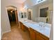 A luxurious bathroom features double sinks and a large mirror, providing ample space and style at 6016 W Gambit Trl, Phoenix, AZ 85083