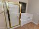The bathroom features a glass shower, a built-in tub, and a decorative glass-block window at 6016 W Gambit Trl, Phoenix, AZ 85083
