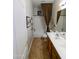 Bathroom features a double sink vanity, tile floors, and a shower and tub combo at 6016 W Gambit Trl, Phoenix, AZ 85083