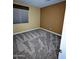 This bedroom features neutral walls, plush carpet, and a window with blinds, creating a cozy and inviting atmosphere at 6016 W Gambit Trl, Phoenix, AZ 85083