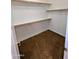 A walk-in closet features carpet, a hanging rod, and shelving to maximize storage space at 6016 W Gambit Trl, Phoenix, AZ 85083