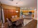 Dining room showcases granite table with seating for six and flows into the updated kitchen at 6016 W Gambit Trl, Phoenix, AZ 85083