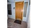 A close view of the wooden front door and sidelight windows at 6016 W Gambit Trl, Phoenix, AZ 85083