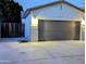 A view of the two car garage with concrete driveway at 6016 W Gambit Trl, Phoenix, AZ 85083