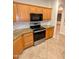 This kitchen is equipped with stainless steel appliances, granite countertops, and wooden cabinets at 6016 W Gambit Trl, Phoenix, AZ 85083