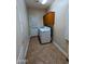 Laundry room features washer, dryer, overhead cabinets, and tile flooring at 6016 W Gambit Trl, Phoenix, AZ 85083