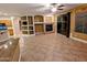 Living room with cozy fireplace, built-in shelving, and direct access to the outside patio at 6016 W Gambit Trl, Phoenix, AZ 85083