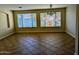 Bright living room featuring tile floors and natural light from the large windows at 6016 W Gambit Trl, Phoenix, AZ 85083