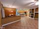 Open concept living spaces with decorative walls, tile floors, and updated kitchen in the background at 6016 W Gambit Trl, Phoenix, AZ 85083