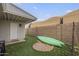 Backyard with artificial grass, a block wall, a shed, and a green kayak at 6251 E Hannibal St, Mesa, AZ 85205