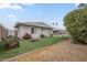 Spacious backyard featuring artificial grass, corn hole, and mature trees at 6251 E Hannibal St, Mesa, AZ 85205