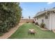 Artificial turf backyard with corn hole game, desert landscaping, and block wall at 6251 E Hannibal St, Mesa, AZ 85205